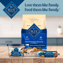 Blue Buffalo dog food tubs with brand bag in background, upright package lineup