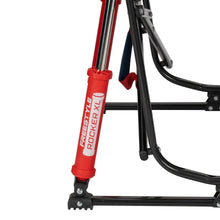 Folding rocking camp chair frame with red shock absorbers and black curved rockers