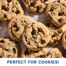 Chocolate chip cookies on parchment, golden-brown with chocolate pieces