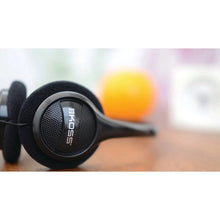 Side view of black Koss on-ear headphones with ear-cup grille