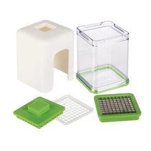 White vegetable chopper with clear container and green cutting grids plus slicer parts