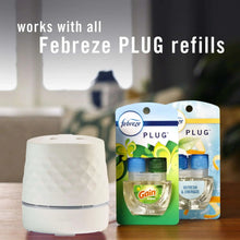 White Febreze Plug oil warmer with refill packs beside it