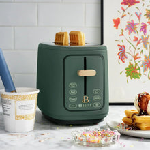 2-slice toaster, dark green, front display lit, with toasting slots