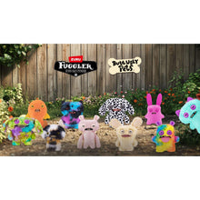 Calico cat ugly pet stuffed toy standing in a group of assorted figures outdoors