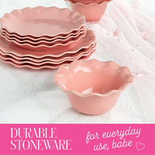 Close-up of rose pink scalloped ruffle rim plates stacked with matching bowl