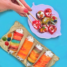 Assorted fruit snack servings on a plate with roll-up slices and fruit-shaped pieces