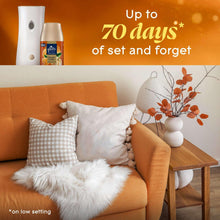 Automatic spray air freshener refill and dispenser on an end table near couch cushions