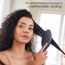 T3 Edge heated smoothing brush being used to straighten a section of curly hair