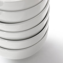 Stacked white porcelain bowls with smooth curved sides