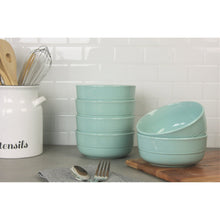Seafoam green ceramic cereal bowls, three stacked with one on the side