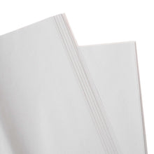 Stack of white packing paper sheets with visible straight edge