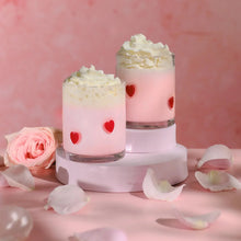 Set of 2 clear drinking glasses with red heart charm decals and pink contents
