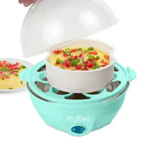 Teal egg cooker with open domed lid steaming in bowl with chopped vegetables