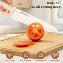 Kitchen knife with white handle and speckled blade cutting tomato on a wooden board
