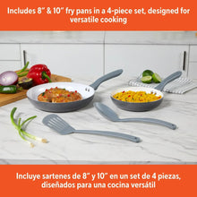 Two gray fry pans with white interiors and four-piece utensil set