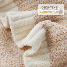 Microfiber throw blanket close-up with Oeko-Tex Standard 100 label on textured knit pile.