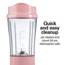 Coral personal blender jar with measurement markings and pink travel lid