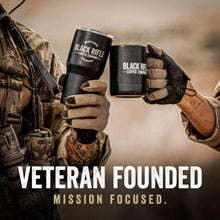 Gloved hands holding Black Rifle Coffee Company coffee mugs