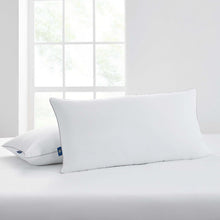 White king bed pillows standing upright, blue corner tag visible