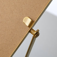 Gold clasp and mirror edge on tabletop mirror frame