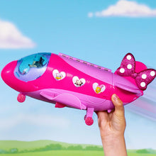 Pink Minnie jet toy with bow fin accessory, held in a hand