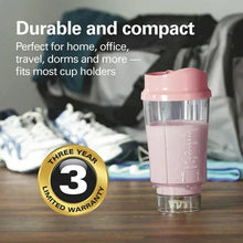 Coral compact personal blender with clear jar and travel lid on a tabletop