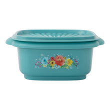 Teal plastic food storage container with lid and floral centerpiece print