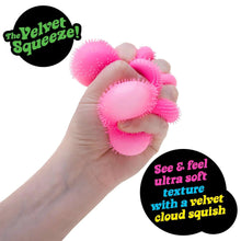 Pink velvety fuzzy flower fidget ball held in a hand