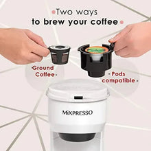 White single-serve coffee brewer with pod and grounds inserts shown in open top