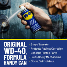 Hand holding WD-40 multi-use spray can with red cap and blue label