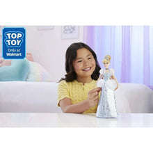 Cinderella fashion doll in glittery light-blue dress, held by a smiling child