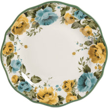 Floral dinner plate with green rim and yellow and blue rose bouquets