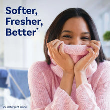 Softened pink towel held by person, fabric softener result