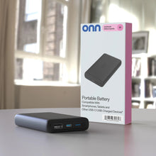 Black portable power bank with dual USB-A and USB-C ports and indicator lights