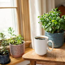 Brewed coffee in a white mug on a wooden table