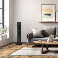 Black tower fan near a living room sofa