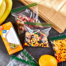 Clear square snack bags with single zipper and green seal strip, filled with snacks