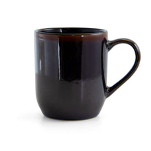 Black ceramic mug with curved handle and glossy finish
