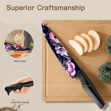 Chef knife with floral blade and black handle on a wooden cutting board