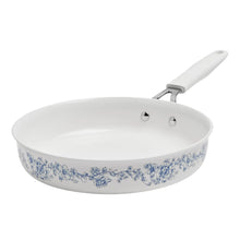 White ceramic frying pan with blue floral print, long handle, and pour spout