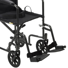 Transport wheelchair side view with black footrests and armrest, steel frame, large caster wheels