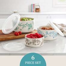Floral stoneware nesting baker bowls with lids and white interiors on a kitchen counter
