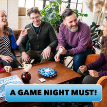 Group playing a word-tile spinner game with a blue board on a living-room table