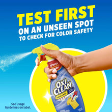 OxiClean stain remover test spot instructions with bottle held in hand