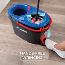 Spin mop wringer bucket with blue top and microfiber mop pad under wringing