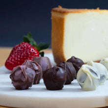 Cheesecake truffle assortment with cheesecake slice, strawberries, and chocolate truffles