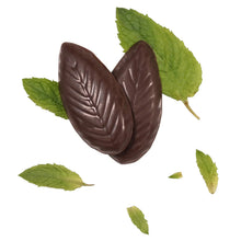 Dark chocolate oval mint pieces with green peppermint leaves scattered