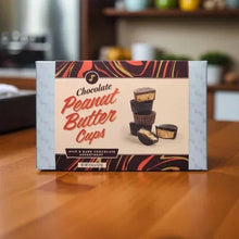 Chocolate peanut butter cups box on table, assorted milk and dark molded cups