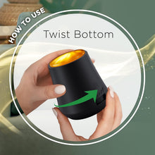 Hand twisting the bottom of a black Air Wick essential mist diffuser