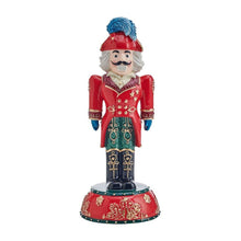 Nutcracker figurine, front view, red coat with gold trim, teal patterned pants, blue hat.